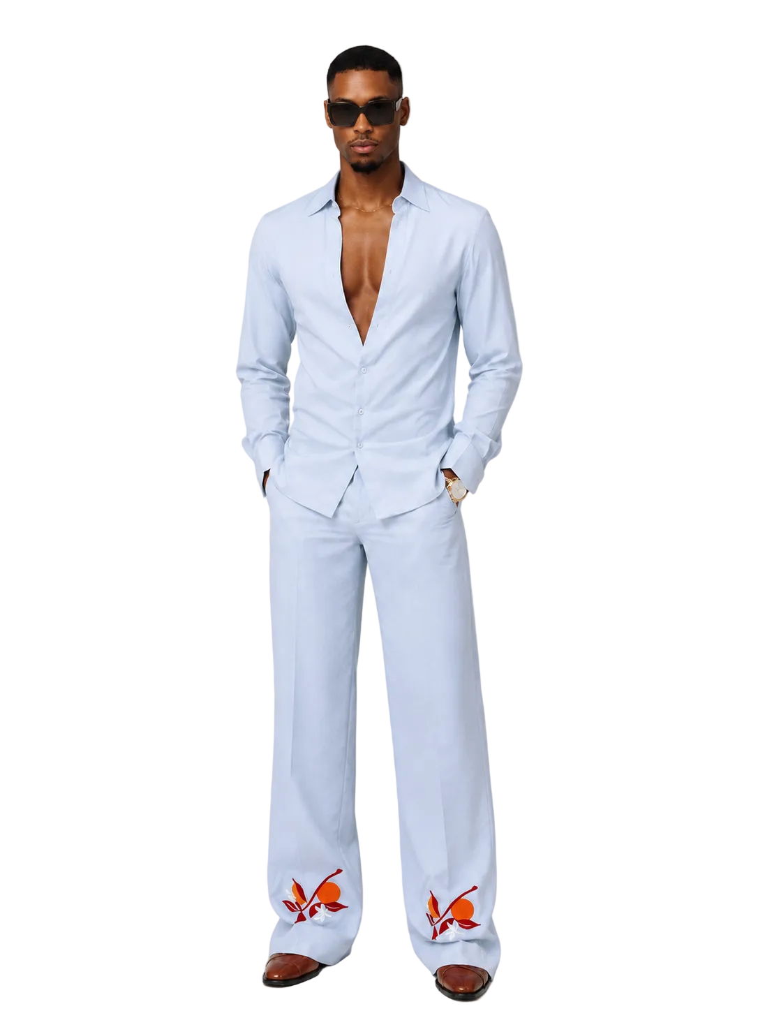 Man wearing a sky blue two piece sets with embroidered orange details